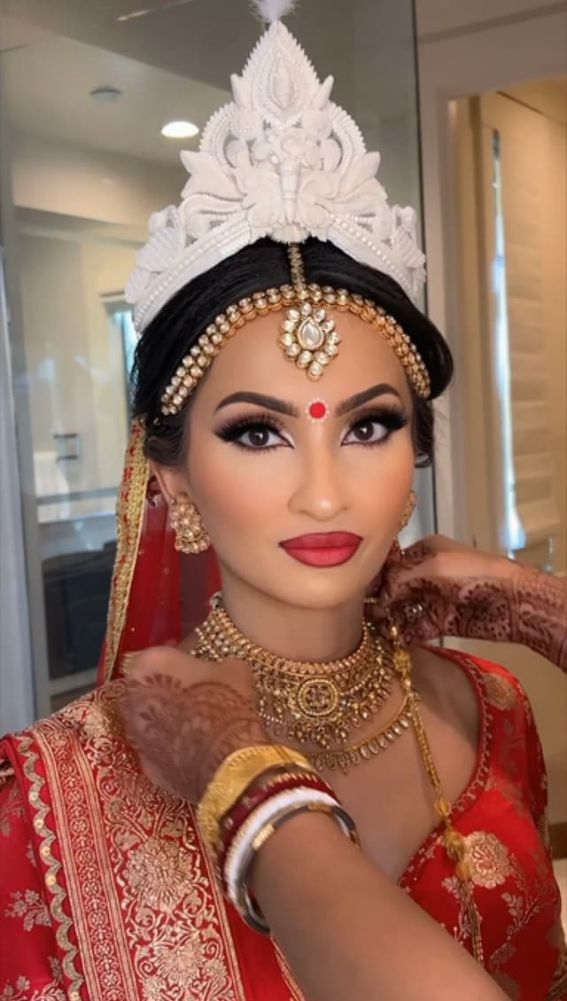 Roko and Shak applying hair style and makeup to bride.