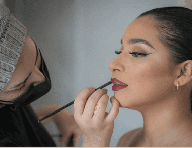 Roko applying lipstick to bride.