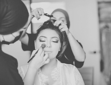 Roko and Shak applying hair style and makeup to bride.